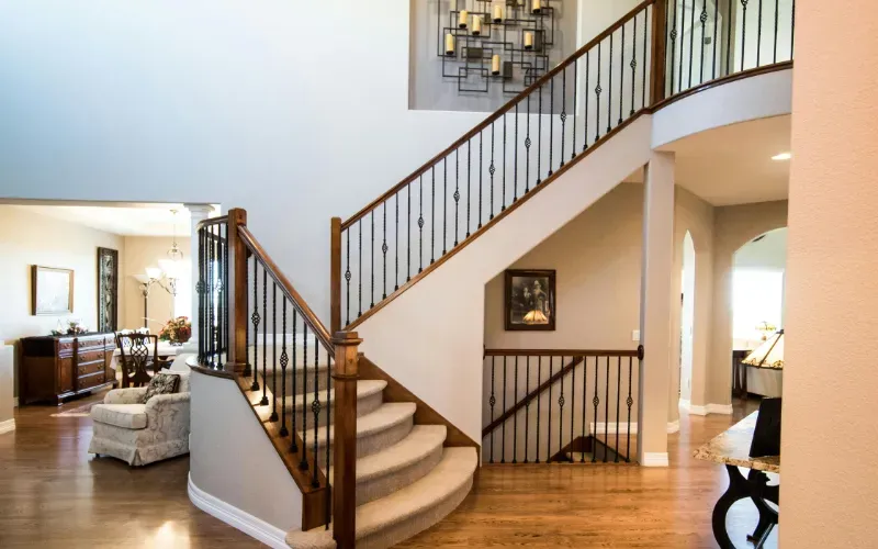 Beautiful staircase with iron railing.